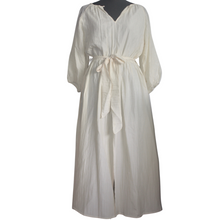A lightweight pale cream, midi length dress in a silk/cotton blend. Front split, balloon sleeves and a tie belt. Perfect resort wear and city wear.